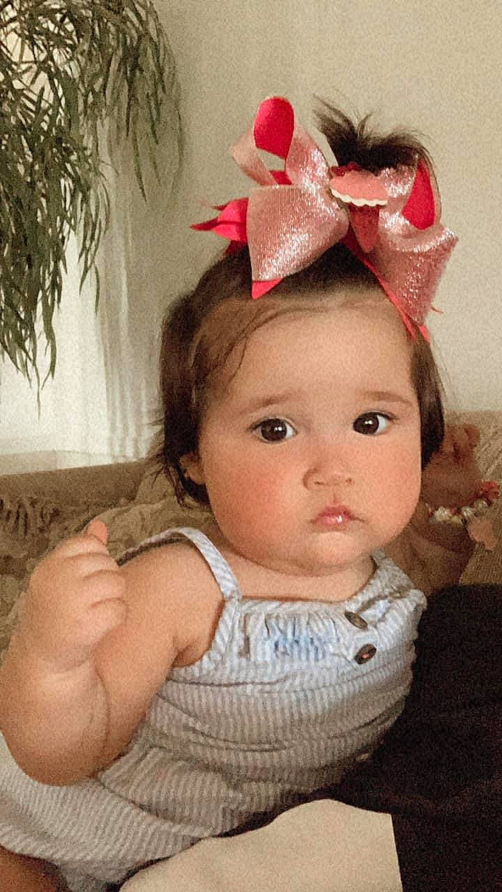 Kilynn is registered to the contest to win money with this photo: cheek, chin, costume_hat, ear, eye, eyebrow, eyelash, face, forehead, hair, head, headgear, human_body, iris, lip, neck, person, pink, plant, skin