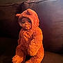 baby, child, costume, bear_costume, plush, couch, furniture, indoors, portrait, person, cute, soft_texture, window, light, seated, cozy, face, hood, warm, expression