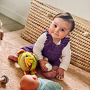 Mia participe au concours pour gagner de l'argent avec cette photo : baby, basket, carpet, casual, child, cute, doll, face, floor, foot, hand, indoor, infant, person, playtime, purple_outfit, room, smile, soft_lighting, toy