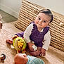 baby, basket, carpet, casual, child, cute, doll, face, floor, foot, hand, indoor, infant, person, playtime, purple_outfit, room, smile, soft_lighting, toy