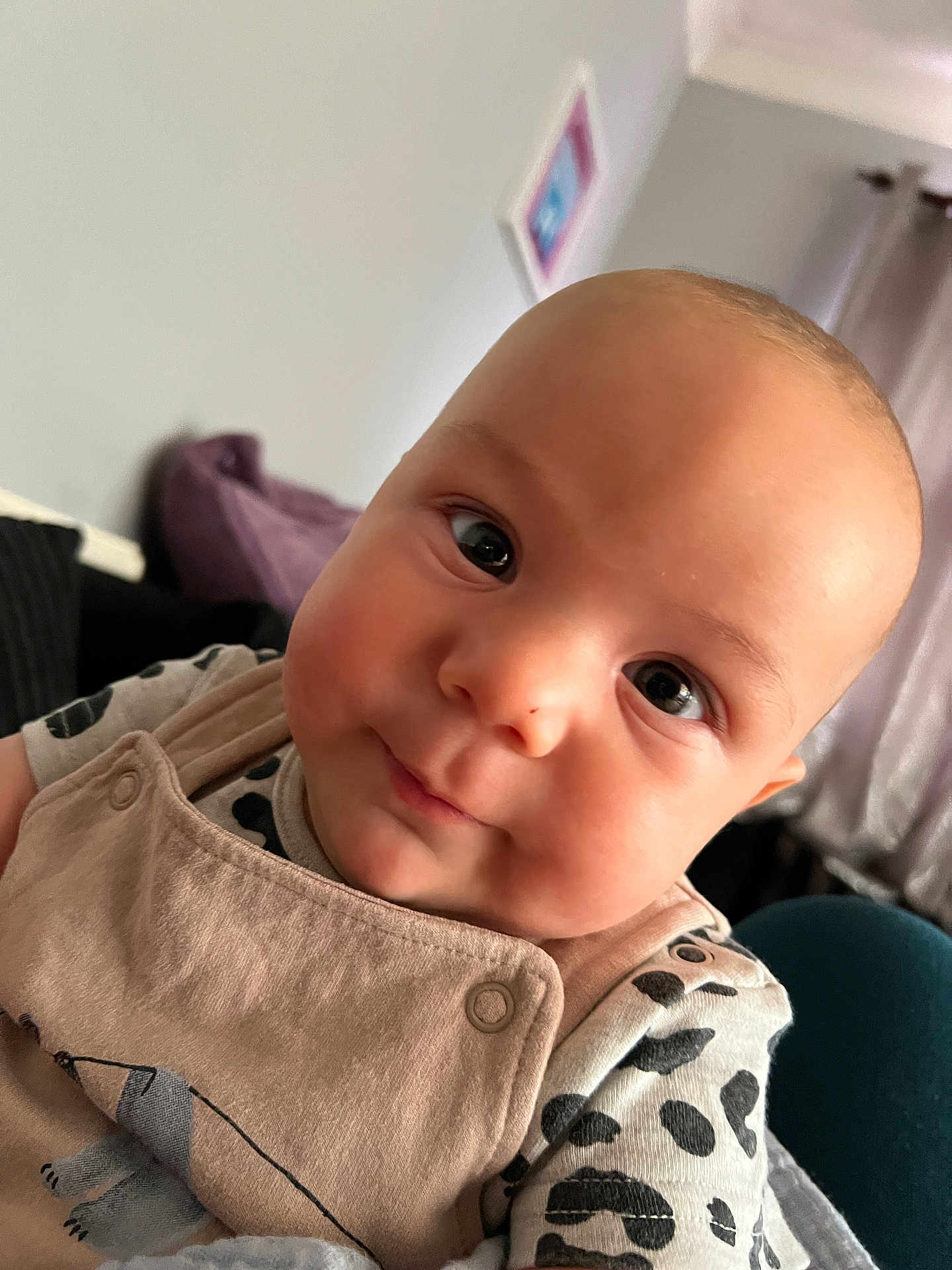 Osi joined the competition — help win amazing prizes! baby, infant, face, eyes, smile, clothing, beige, overall, shirt, spotted, indoor, curious, closeup, young_child, skin, head, cheeks, cute, portrait, person