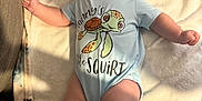 Arlen-Ray is registered to the contest to win money with this photo: arms, baby, blanket, child, clothing, comfort, cozy, cute, expression, face, happy, indoors, infant, legs, lying_down, onesie, skin, smiling, soft_texture, turtle