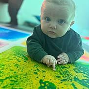 Arlen-Ray is registered to the contest to win money with this photo: baby, blue_eyes, child, closeup, colorful, crawling, curious, cute, floor, hands, indoor, infant, long_sleeve, pattern, person, playmat, pointing, portrait, soft_focus, young