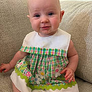 Naomi joined the competition — help win amazing prizes! baby, child, infant, dress, plaid, flowers, embroidery, green, white, couch, furniture, sitting, skin, face, smile, hand, foot, indoors, cute, portrait
