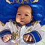 Noah joined the competition — help win amazing prizes! baby, child, infant, blue_clothing, gold_embroidery, crown, name, soft_surface, portrait, cute, costume, white_background, young_child, hands, face, eyes, expression, fabric, decorative, laying_down