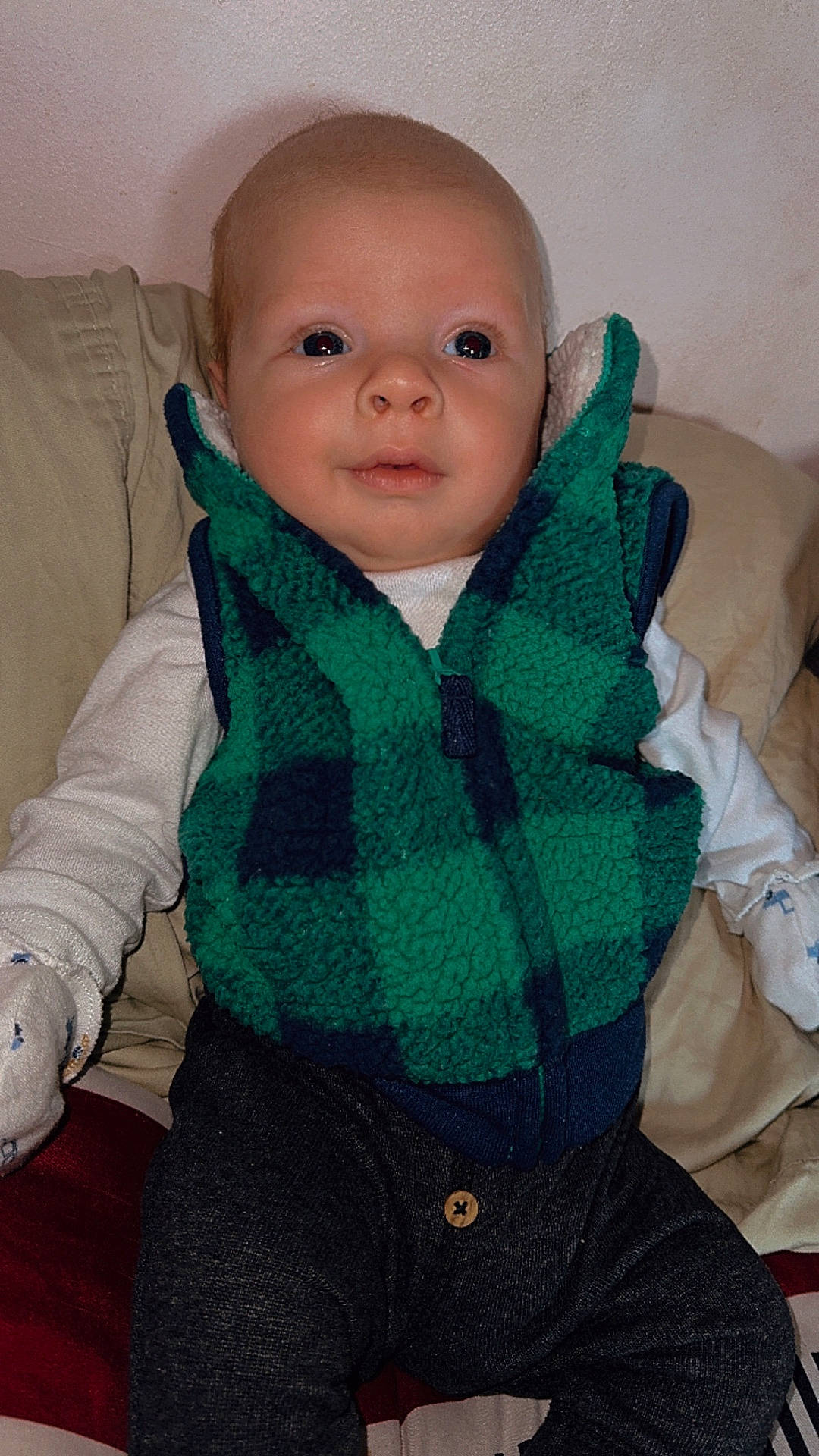 Rally is registered to the contest to win money with this photo: baby, blanket, clothing, coat, couch, cushion, face, furniture, head, homedecor, hoodie, jeans, knitwear, pants, person, photography, portrait, scarf, sweater, sweatshirt