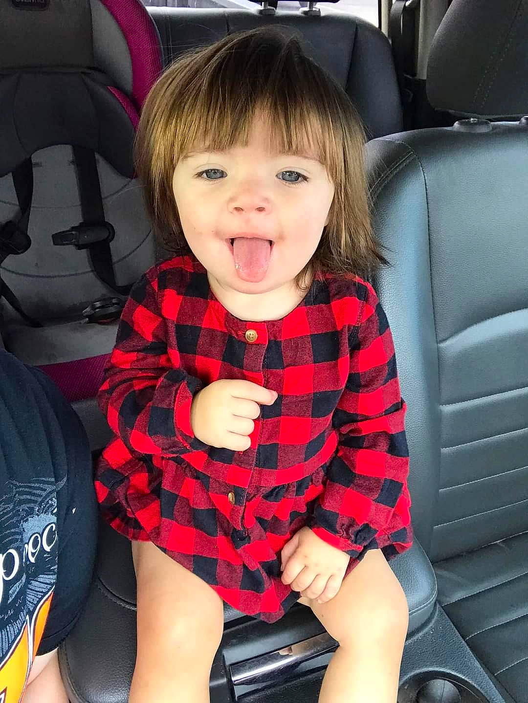 Ryleigh is registered to the contest to win money with this photo: baby_toddler_clothing, black, child, comfort, eye, facial_expression, hairstyle, happy, head, human, knee, person, plaid, product, skin, sleeve, smile, tartan, thigh, toddler