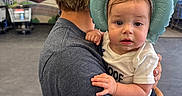 Madelynn is registered to the contest to win money with this photo: adult, baby, background, cap, casual_clothing, child, curious, elephant_hat, expression, gray_shirt, hand, holding, indoor, inflatable_hat, mural, person, portrait, shopping_cart, store, toddler