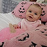 baby, infant, child, portrait, smiling, blue_eyes, bed, blanket, pink, pumpkin, halloween, plush, cozy, indoors, sitting, bib, clothing, couch, soft_texture, cute