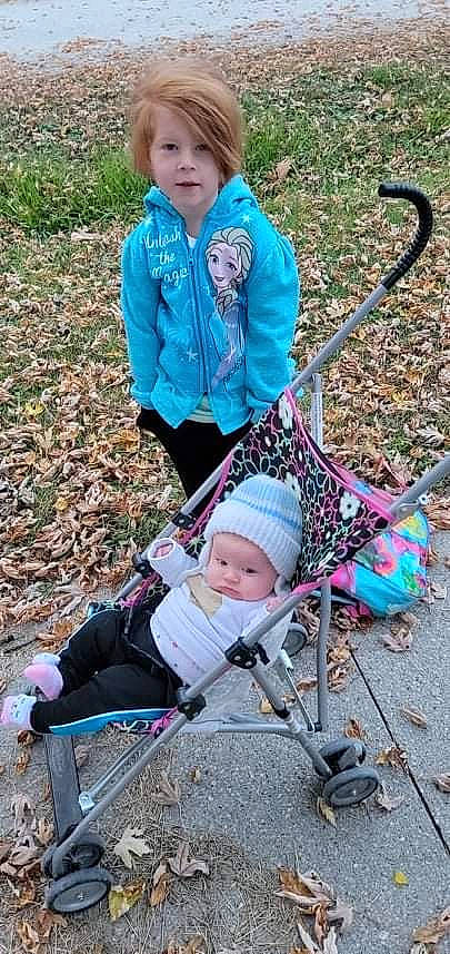 Lilith is registered to the contest to win money with this photo: baby, baby_carriage, blue, child, grass, green, headwear, leaf, leisure, mammal, nature, people, people_in_nature, person, photograph, product, public_space, recreation, toddler, vertebrate