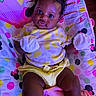 Zahara is registered to the contest to win money with this photo: baby, infant, child, mittens, yellow_clothing, minnie_mouse, baby_seat, colorful, cute, portrait, indoor, playful, curly_hair, happy, young_child, polka_dots, soft_toys, fabric, closeup, smiling