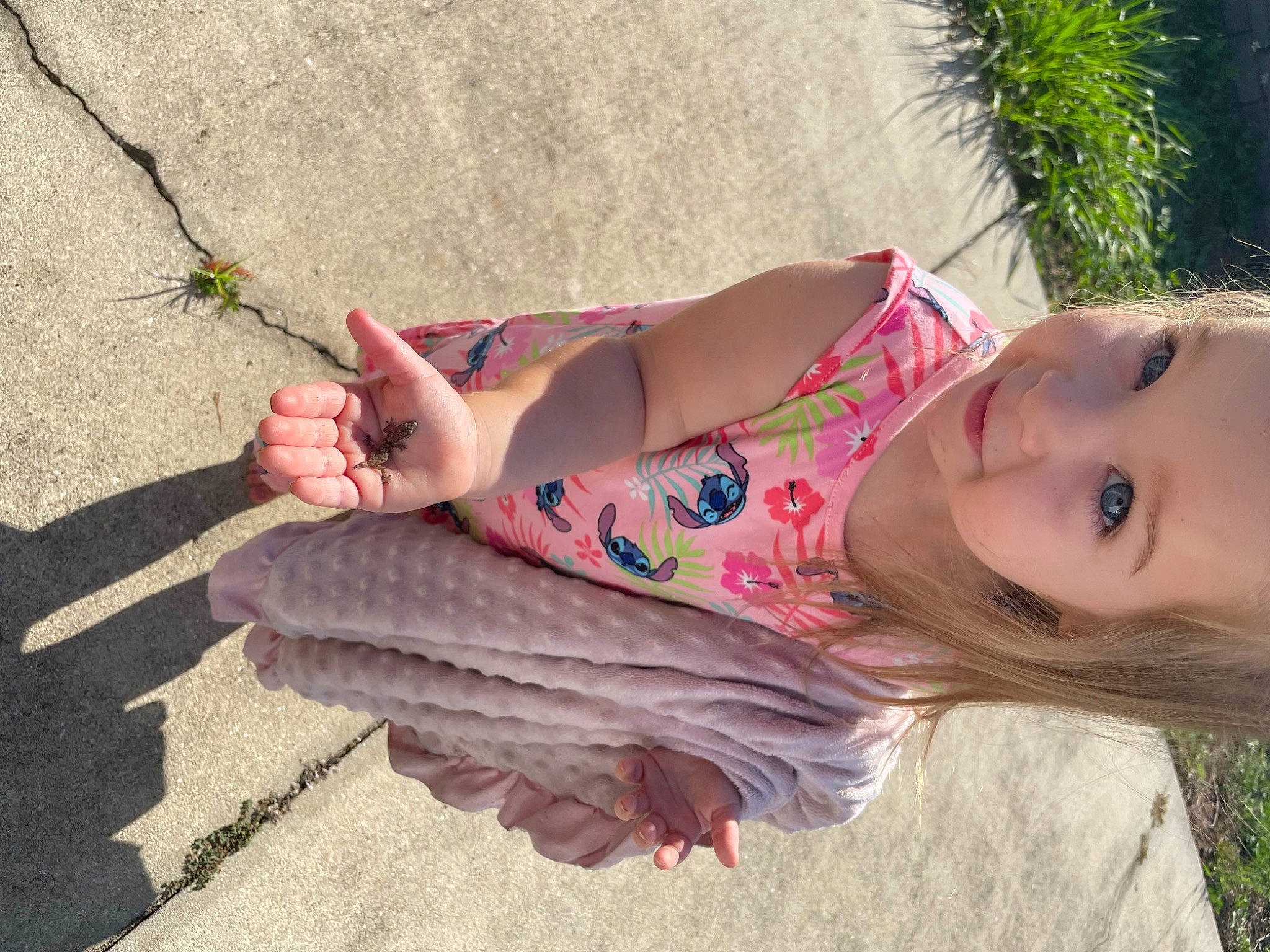 Lilliana is registered to the contest to win money with this photo: dress, finger, grass, hand, happy, human_leg, knee, leaf, leg, leisure, lip, people_in_nature, person, pink, plant, skin, smile, thigh, toddler, tree