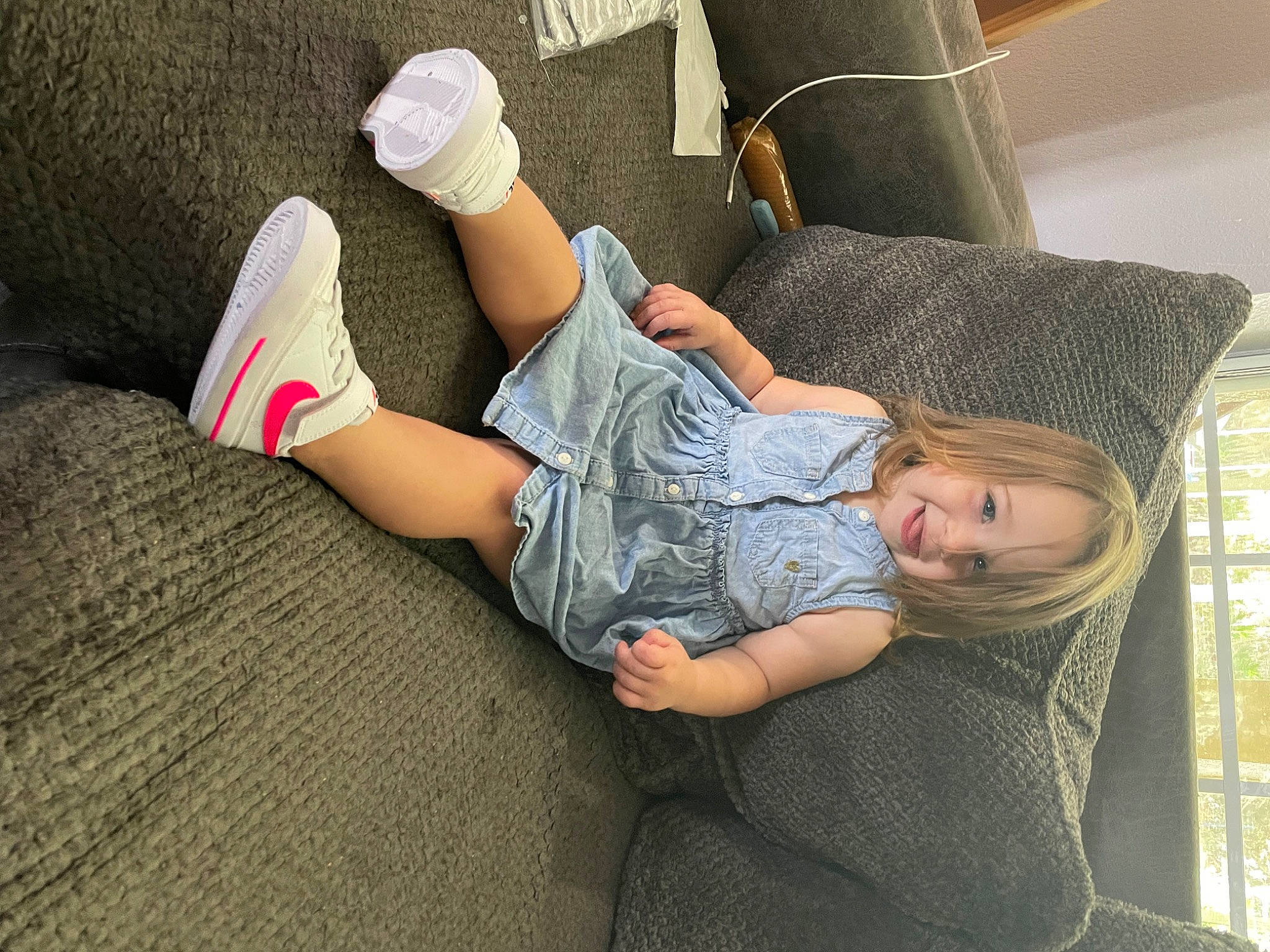 Lilliana is registered to the contest to win money with this photo: car_seat, child, comfort, couch, elbow, finger, foot, gesture, human_leg, joint, joy, knee, leisure, linens, person, room, sitting, sock, t_shirt, textile