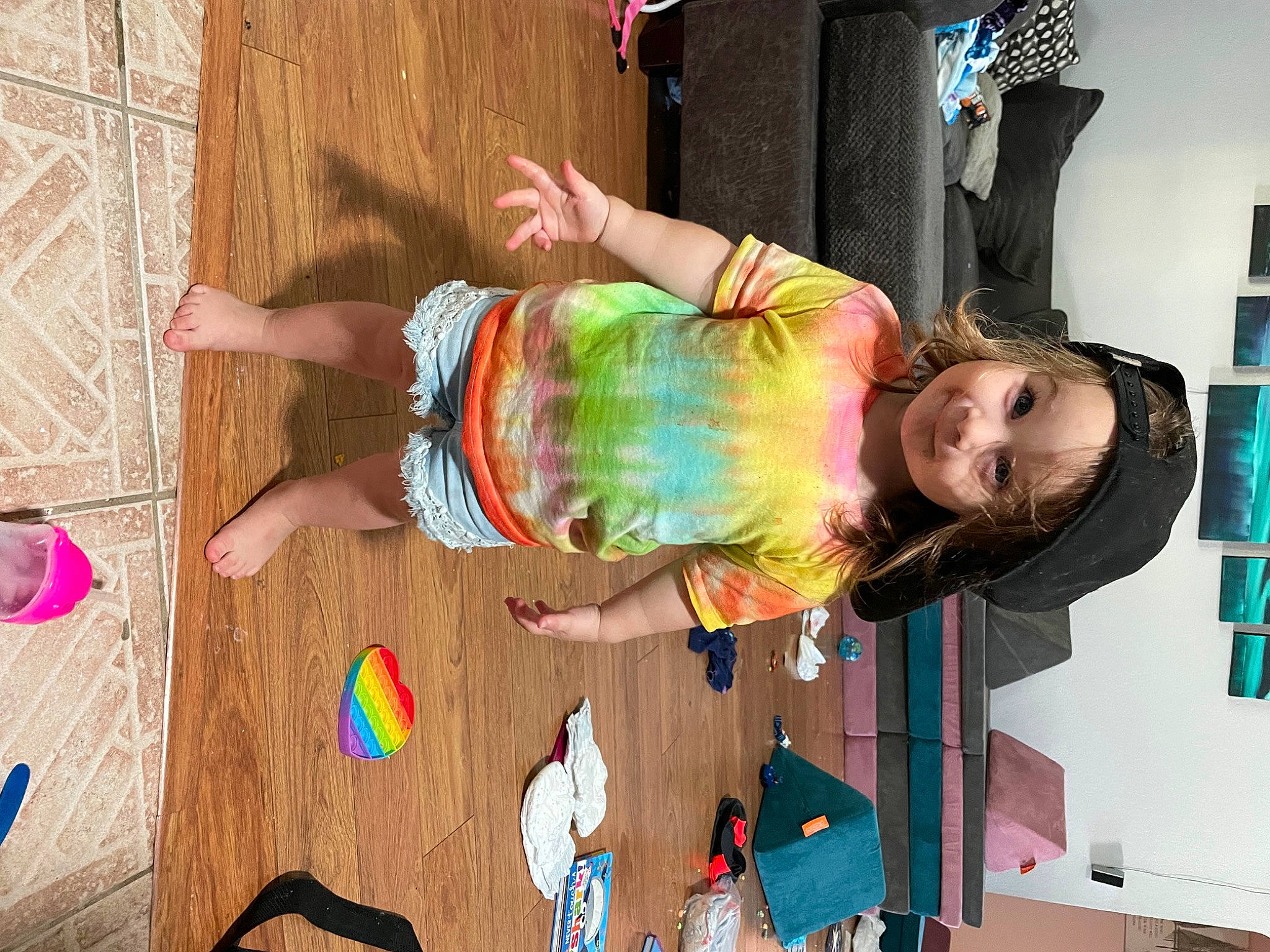 Lilliana is registered to the contest to win money with this photo: beauty, child, flooring, fun, happy, headwear, human_leg, leisure, magenta, pattern, person, pink, play, room, sandal, thigh, toddler, vacation, visual_arts, wood