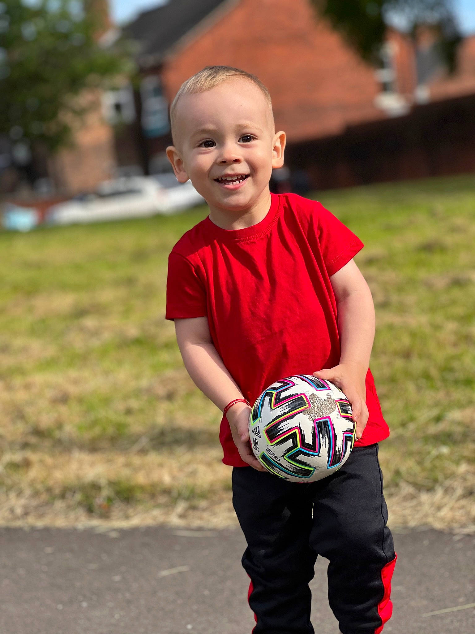 Mateo is registered to the contest to win money with this photo: ball, ball_game, face, finger, flash_photography, football, grass, handball_player, happy, joy, people_in_nature, person, plant, player, playing_sports, shorts, smile, soccer_ball, sports_equipment, sports_uniform