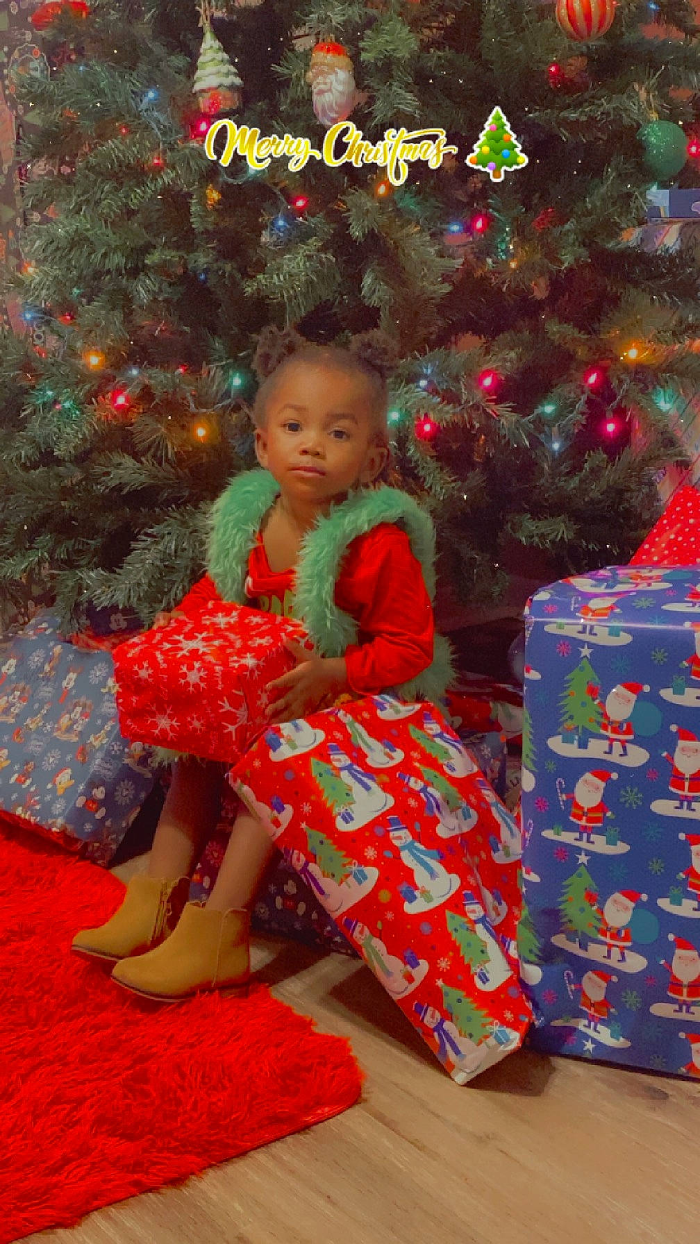 Kayleigh joined the competition — help win amazing prizes! christmas_decoration, christmas_ornament, christmas_tree, dress, event, evergreen, flooring, fun, happy, holiday, holiday_ornament, human_body, one_piece_garment, ornament, pattern, person, sleeve, standing, toddler, tradition