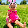 Soulana is registered to the contest to win money with this photo: baby, barefoot, bunny_ears, child, cute, grass, greenery, happy, headwear, infant, nature, outdoor, person, pink_dress, playful, portrait, sitting, smile, summer, sunny