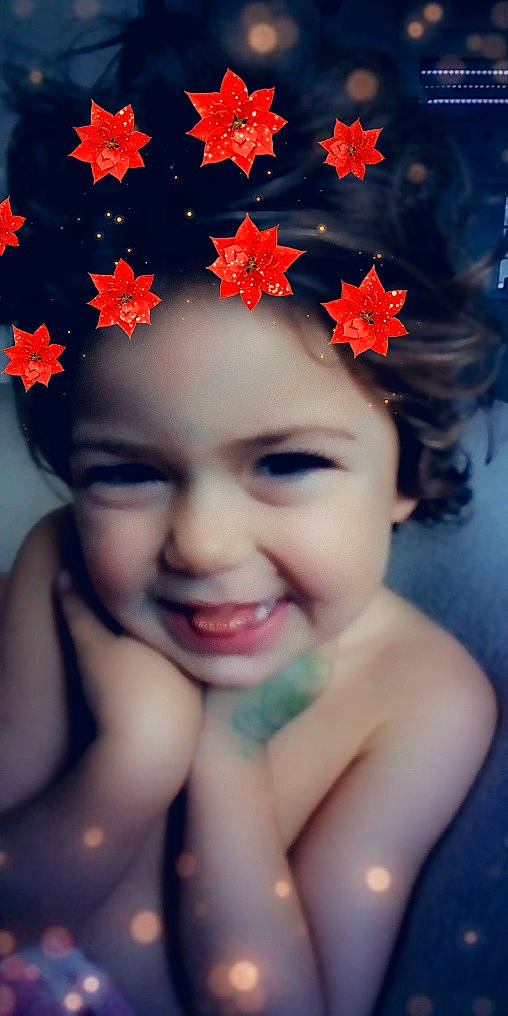 Elvira participe au concours pour gagner de l'argent avec cette photo : beauty, black_hair, cheek, child, eye, face, flower, fun, girl, hair_accessory, happiness, infant, joy, lip, person, petal, plant, portrait, red, smile