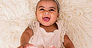 Delilah joined the competition — help win amazing prizes! apparel, baby, child, closeup, cream_color, cute, cute_outfit, delight, expression, fluffy_rug, happy, headband, indoor, infant, joy, portrait, reaching_out, skin, smiling, soft_texture