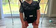 Silas joined the competition — help win amazing prizes! baby_jumper, black_shirt, child, clothing, daylight, floor, fun, happy, home, indoor, person, playful, shoe, shorts, smiling, sneaker, standing, toddler, window, young_child