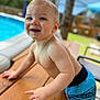 Silas joined the competition — help win amazing prizes! backyard, blue, casual, child, daytime, face, happy, nature, outdoor, person, playful, pool, skin, smiling, summer, sunlight, swim_trunks, toddler, water, wooden_table