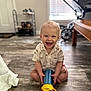 Silas joined the competition — help win amazing prizes! baby, child, clothing, door, floor, furniture, happy, home, indoor, person, play, shelf, shirt, shorts, smiling, stroller, toddler, toy, window, wood_floor