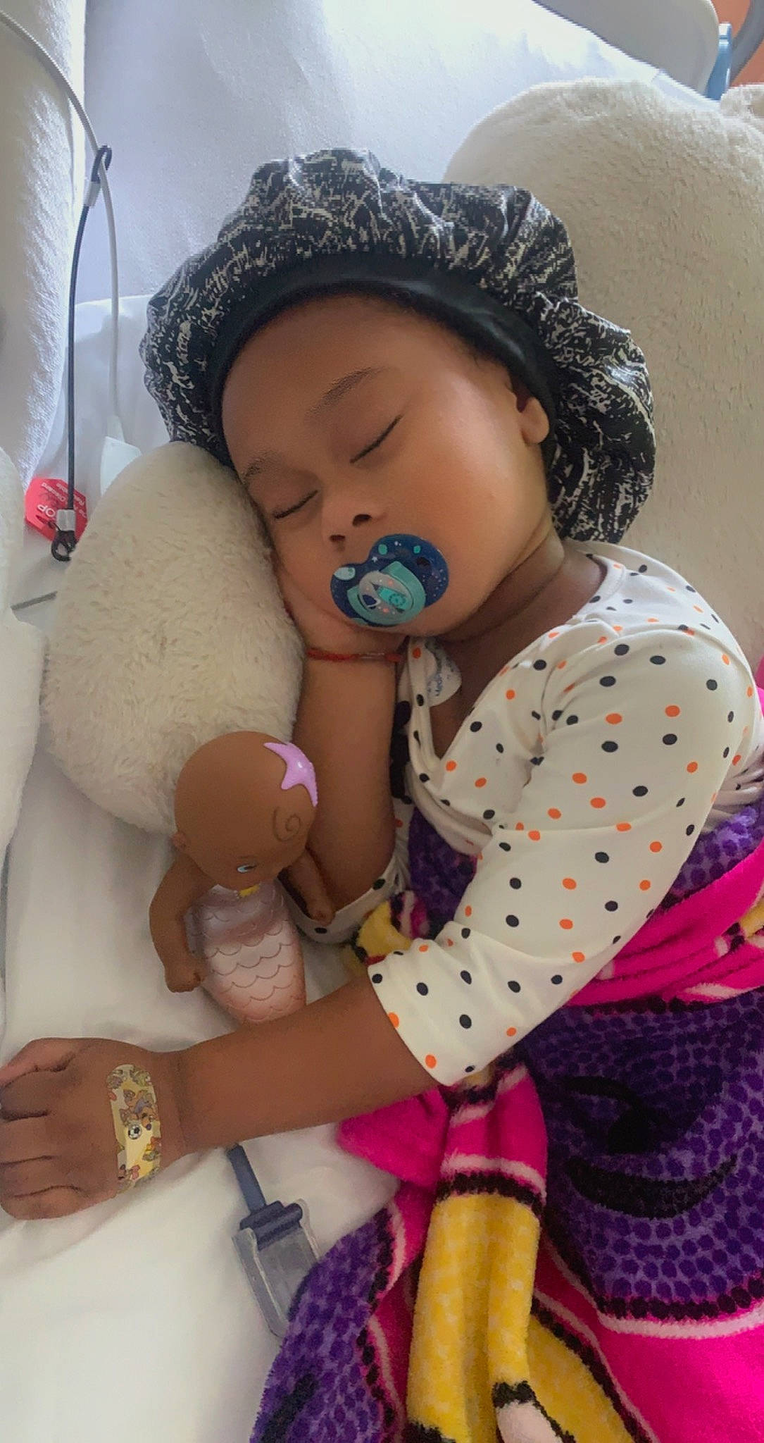 Kali is registered to the contest to win money with this photo: arm, baby_toddler_clothing, cap, cheek, child, comfort, doll, finger, headwear, joint, nose, organ, pattern, person, pink, plush, product, skin, sleeve, stuffed_toy