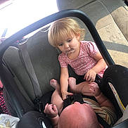 Giavonni joined the competition — help win amazing prizes! toddler, baby, car_seat, car_interior, child, seatbelt, pink_shirt, striped_outfit, blond_hair, infant, curious, car_window, seat, sibling, interaction, safety_harness, childrens_clothing, automobile, family, inside