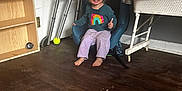 Gia is registered to the contest to win money with this photo: architecture, baby, chair, clothing, face, furniture, hardwood, head, indoors, interiordesign, jeans, maceclub, pants, person, photography, plywood, portrait, sitting, weapon, wood