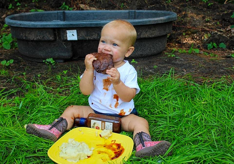 Laney joined the competition — help win amazing prizes! baby, baby_toddler_clothing, child, food, fun, grass, green, groundcover, happy, lawn, leisure, people_in_nature, person, plant, recreation, sandal, sharing, sitting, summer, toddler