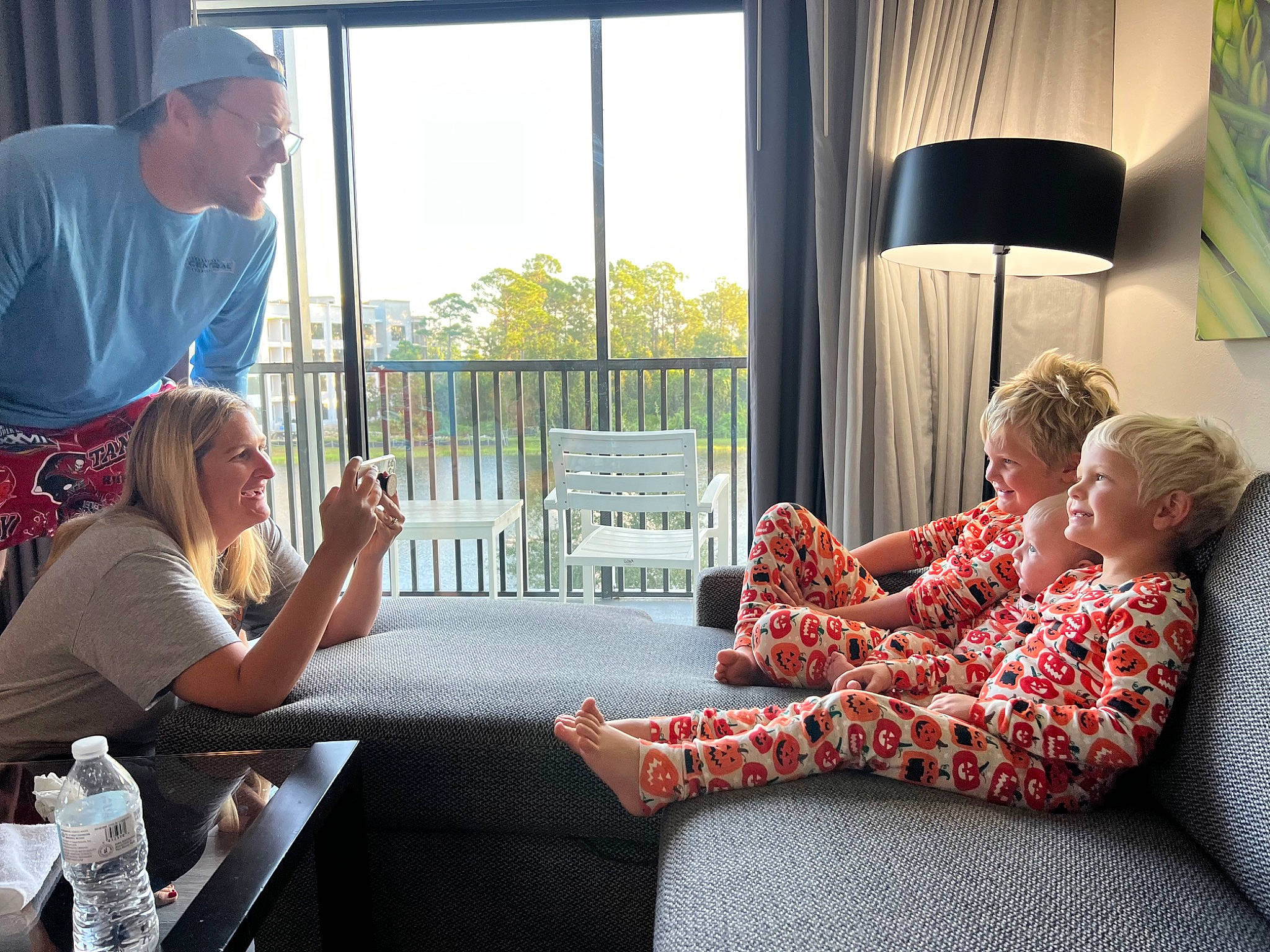 Dallas is registered to the contest to win money with this photo: baseball_cap, chair, child, comfort, couch, curtain, event, fence, fun, furniture, interior_design, joy, leisure, living_room, person, recreation, room, sitting, t_shirt, table