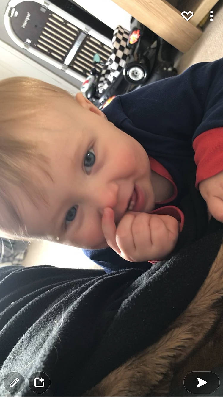 Reagan is registered to the contest to win money with this photo: audio_equipment, baby, baby_toddler_clothing, cheek, child, comfort, eyebrow, eyelash, finger, flash_photography, fun, gesture, happy, iris, mouth, nose, person, skin, sleeve, thumb