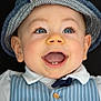 Malo participe au concours pour gagner de l'argent avec cette photo : baby, child, smiling, blue_eyes, hat, vest, white_shirt, teeth, happy, portrait, face, long_eyelashes, cute, infant, fashion, closeup, expression, background, clothing, person