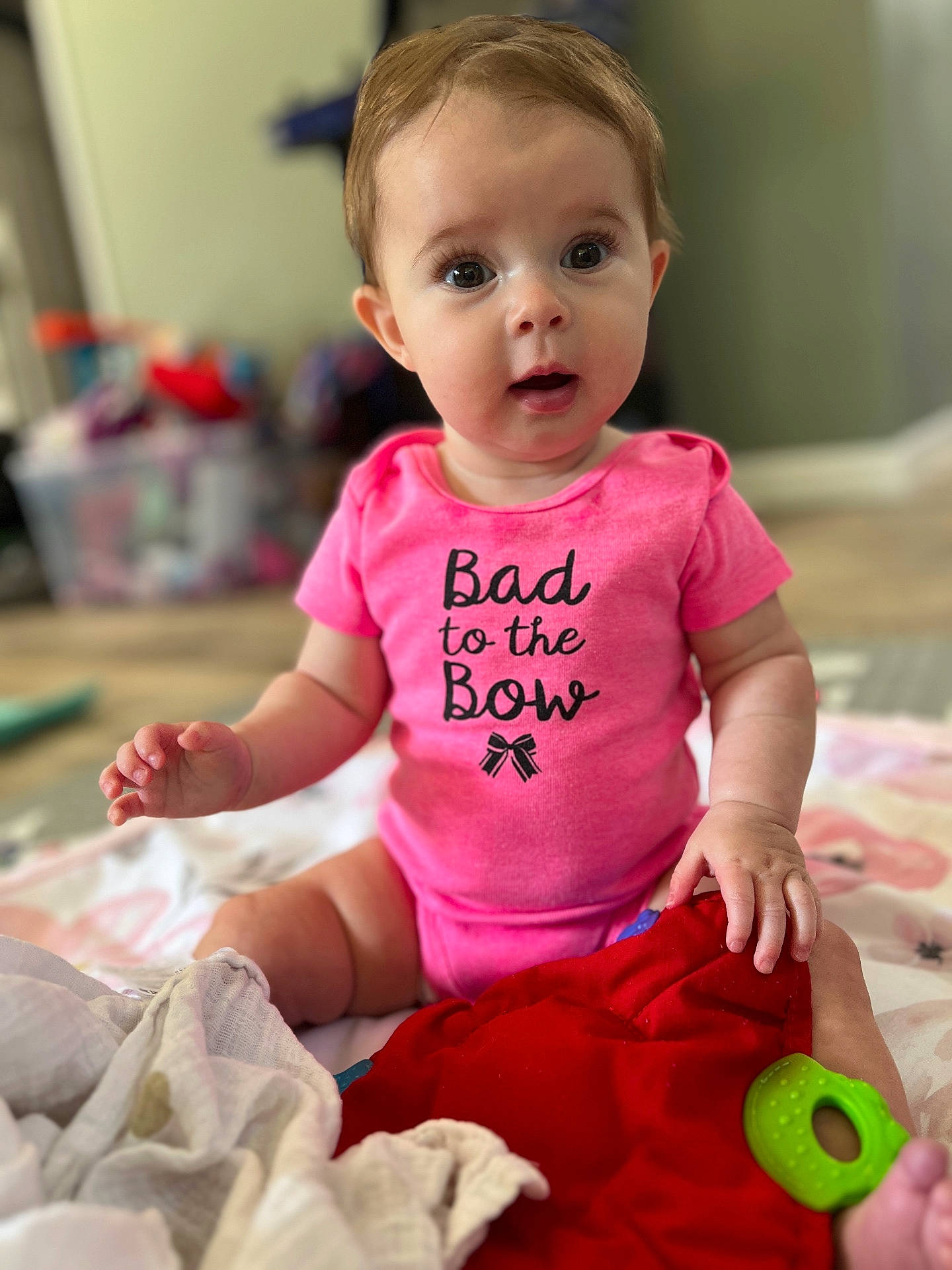 Mylah is registered to the contest to win money with this photo: baby, bed, bedroom, bodypart, clothing, couch, dress, face, finger, furniture, hand, head, indoors, newborn, person, photography, portrait, room, sitting, t_shirt