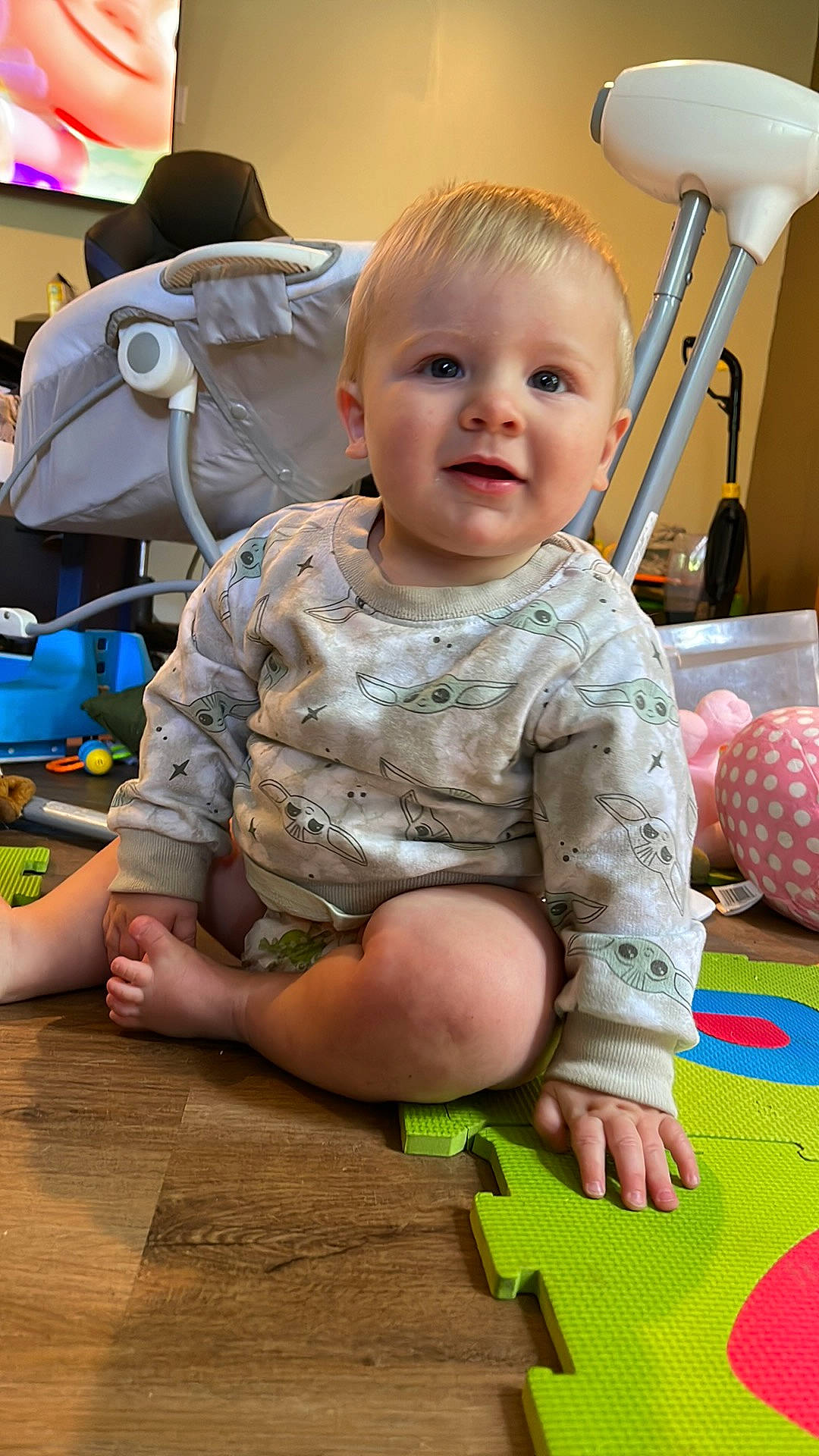 Kain is registered to the contest to win money with this photo: arm, baby, baby_toddler_clothing, cheek, child, fedora, floor, flooring, fun, green, hat, joint, leisure, pattern, person, sitting, skin, standing, sun_hat, toddler