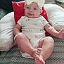 Macie is registered to the contest to win money with this photo: baby, blanket, bow, child, comfortable, couch, cute, feet, headband, home, indoor, infant, legs, living_room, onesie, person, pillow, relaxing, smile, soft