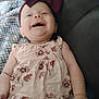 Macie is registered to the contest to win money with this photo: baby, blanket, bow, child, clothing, couch, cute, dress, face, floral, happy, headband, indoors, infant, person, portrait, relaxing, skin, smiling, young_child