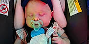 Macie joined the competition — help win amazing prizes! baby, sleeping, pacifier, car_seat, blanket, headband, infant, child, cute, resting, safety, warning_label, clothing, soft, peaceful, indoors, person, small_hand, comfort, adorable