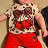 baby, child, smiling, laughing, red_pants, shirt, cherries, leopard_print, bow, happy, cute, infant, lying_down, clothing, texture, indoor, person, toddler, face, joyful