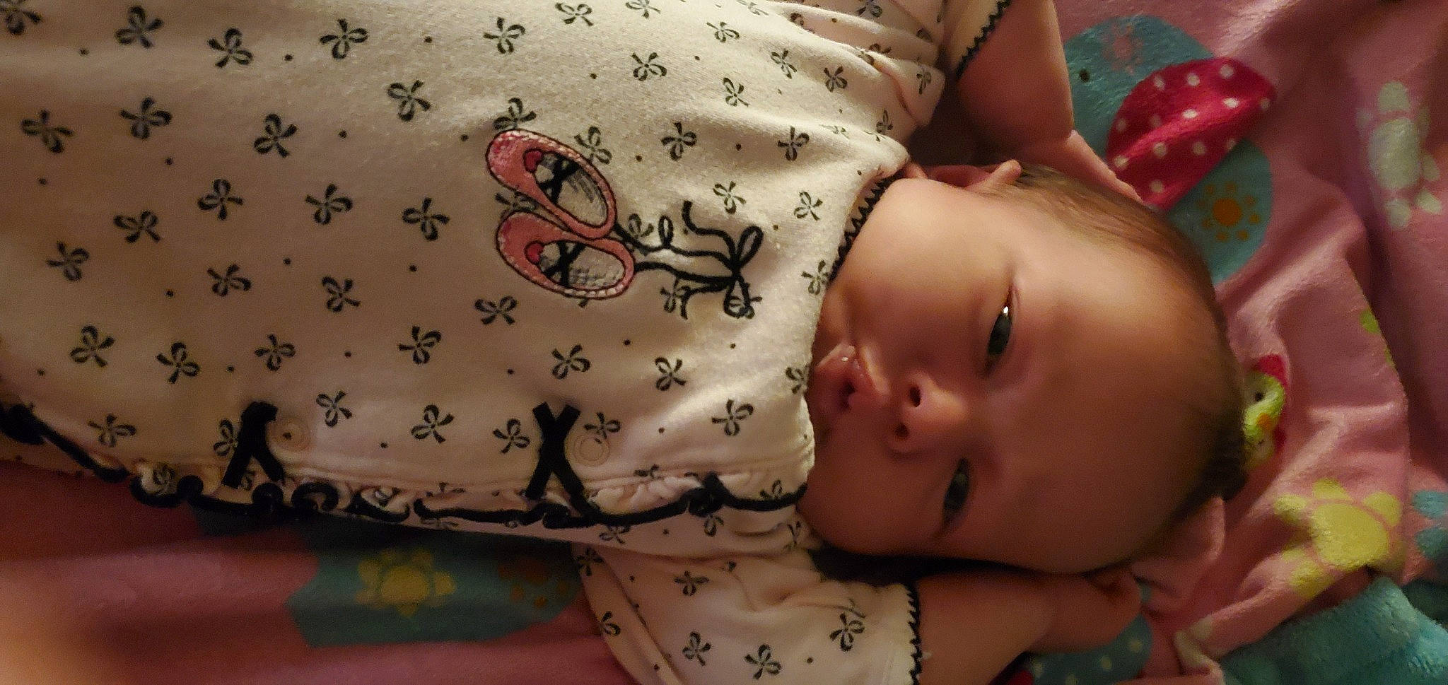 Addalyn is registered to the contest to win money with this photo: abdomen, baby, baby_toddler_clothing, cheek, chest, child, comfort, finger, hand, headgear, human_body, linens, mouth, neck, pattern, person, pink, skin, sleeve, textile