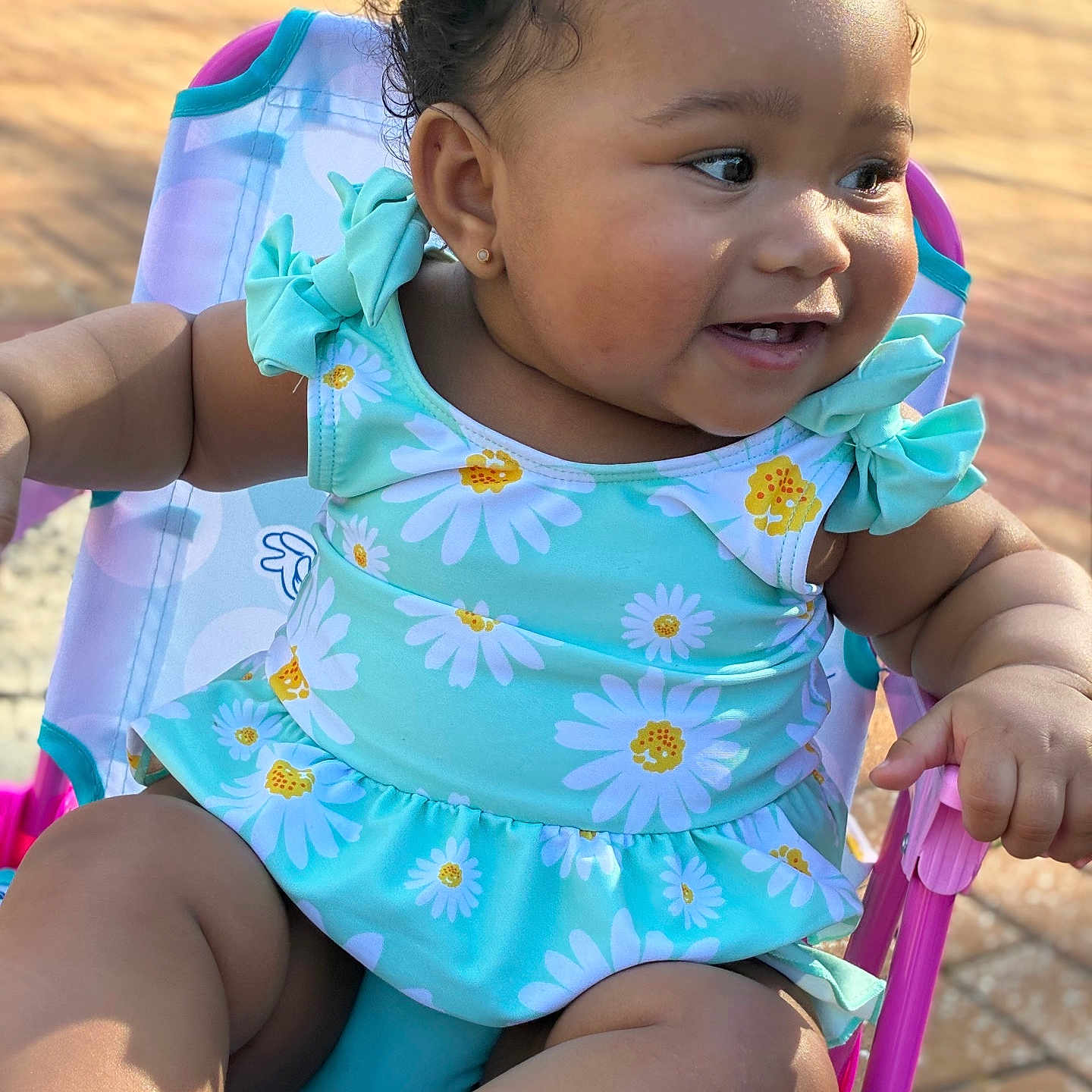 Reality joined the competition — help win amazing prizes! baby, baby_girl, chair, child, close_up, colorful, curly_hair, cute, daisy_dress, earrings, happy, infant, outdoor, playful, portrait, sitting, skin, smiling, summer, sunlight