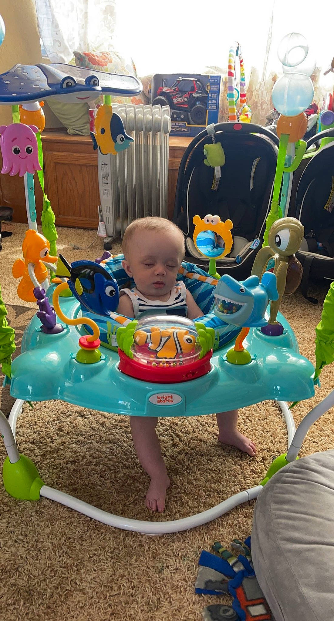 Jagger is registered to the contest to win money with this photo: amusement_ride, baby, baby_products, baby_toddler_clothing, baby_toys, blue, child, city, event, fun, grass, leisure, person, photograph, plastic, play, recreation, sitting, toddler, toy