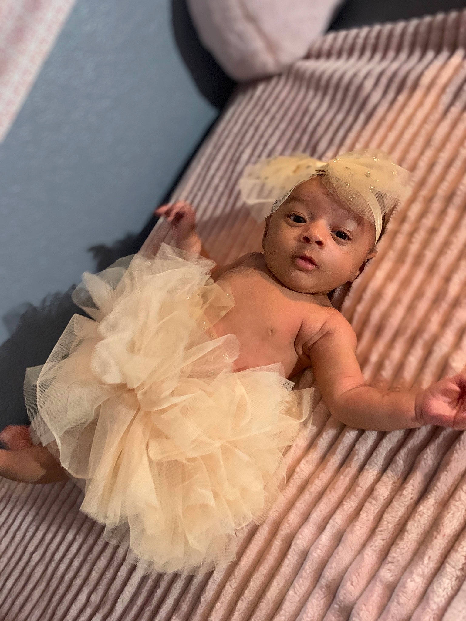 Ailani joined the competition — help win amazing prizes! baby, baby_toddler_clothing, child_model, costume, costume_accessory, day_dress, embellishment, foot, linens, peach, person, ruffle, skin