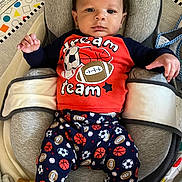 Kai joined the competition — help win amazing prizes! baby, infant, child, cushion, seat, clothing, sports_theme, football, basketball, soccer_ball, baseball, play_mat, lotion_bottle, indoor, portrait, young_child, cute, resting, baby_seat, colorful_background
