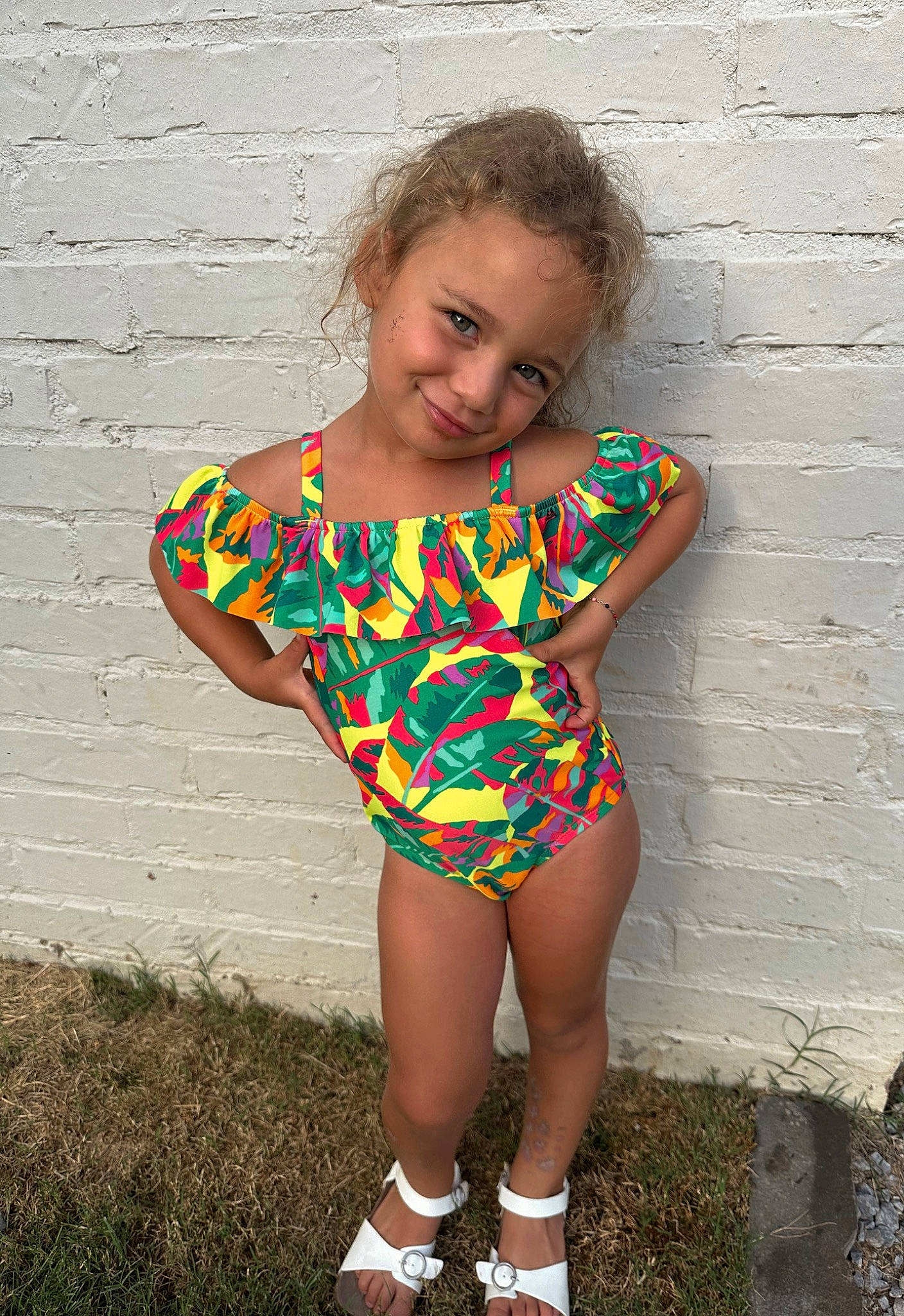 Saylor is registered to the contest to win money with this photo: baby_toddler_clothing, brick, day_dress, dress, flash_photography, grass, happy, head, human_body, human_leg, joy, knee, one_piece_garment, pattern, people_in_nature, person, sitting, smile, t_shirt, thigh