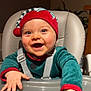 baby, infant, high_chair, smile, elf_hat, holiday_outfit, green_clothing, red_hat, blue_eyes, rosy_cheeks, hands, tray, straps, seat, cute, portrait, indoor, happy, child, person