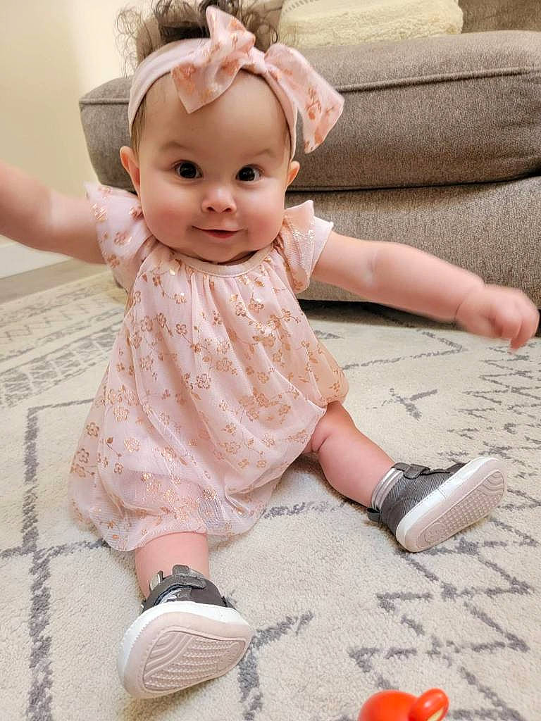 Taya joined the competition — help win amazing prizes! baby, baby_toddler_clothing, beauty, cheek, child, dress, embellishment, finger, floor, flooring, happy, human_leg, nail, pattern, person, pink, skin, sleeve, smile, toddler