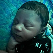 Henry is registered to the contest to win money with this photo: baby, sleeping, infant, face, hand, blanket, clothing, pattern, blue, black, peaceful, closeup, young_child, resting, indoors, portrait, skin, head, cute, peace