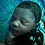 baby, sleeping, infant, face, hand, blanket, clothing, pattern, blue, black, peaceful, closeup, young_child, resting, indoors, portrait, skin, head, cute, peace