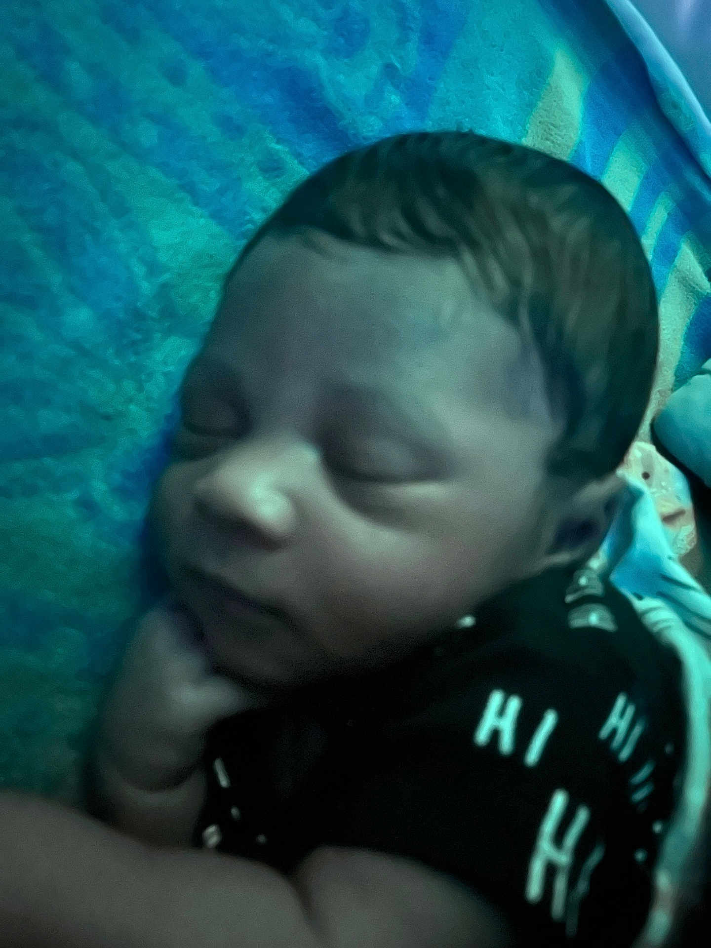 Henry is registered to the contest to win money with this photo: baby, sleeping, infant, face, hand, blanket, clothing, pattern, blue, black, peaceful, closeup, young_child, resting, indoors, portrait, skin, head, cute, peace